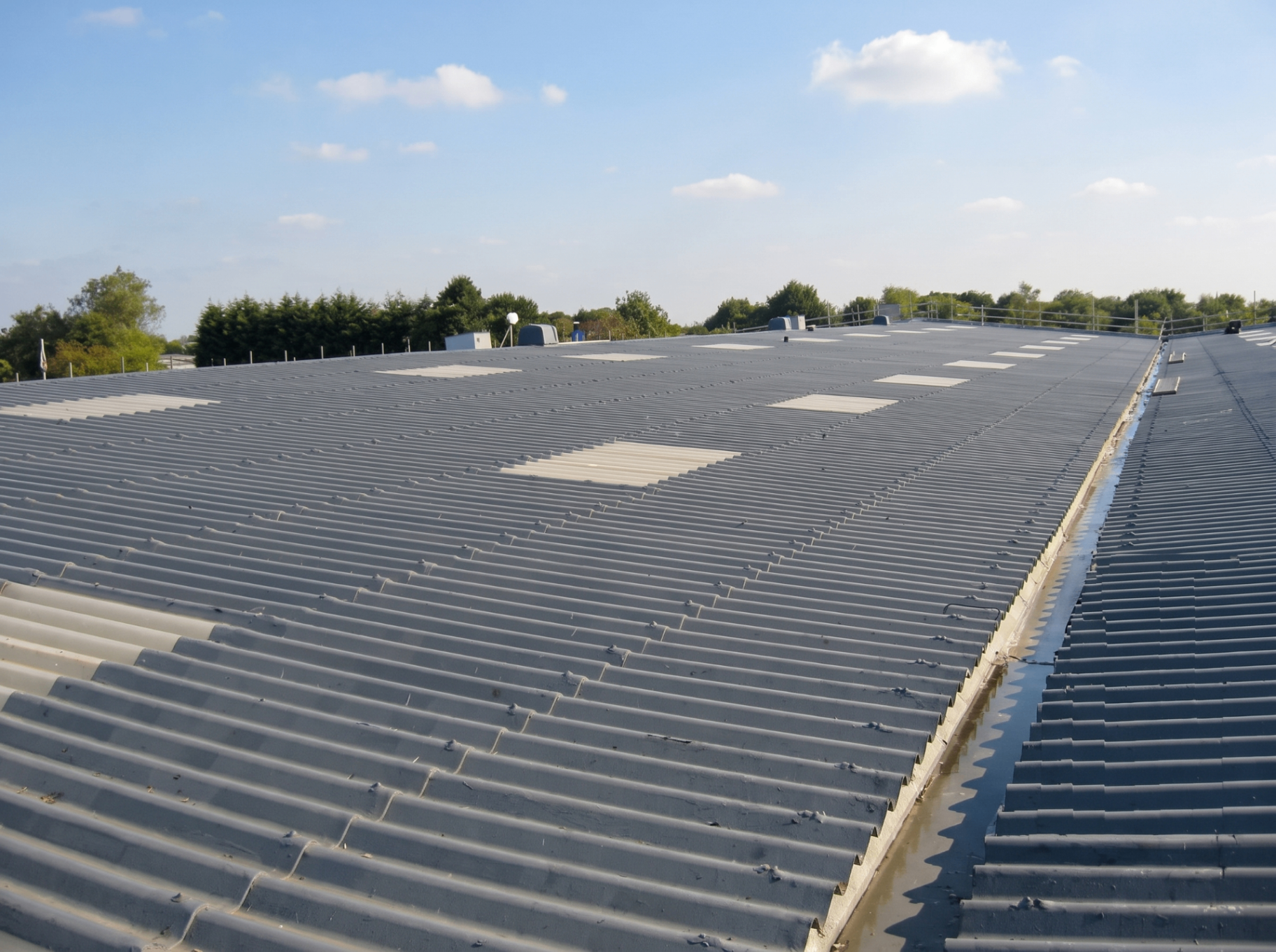 Sealed asbestos roof with protective coating